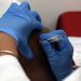 Doctors group recommends COVID vaccine for all adults in break with government